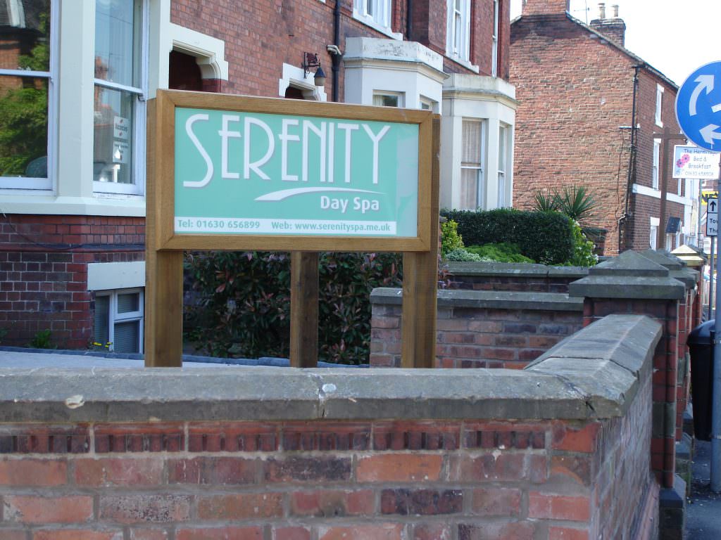A corporate entrance sign supplied complete with an oak frame and oak posts – positioned outside the office