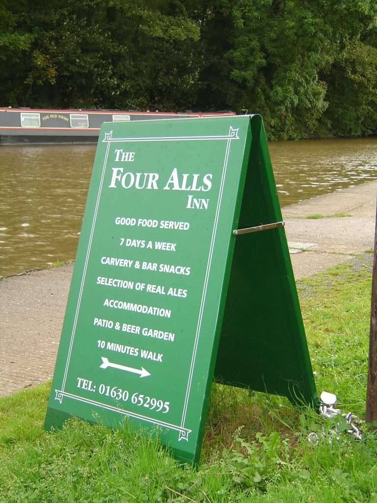 An aluminium Pavement A frame, finished in dark green with white vinyl lettering.  Suitable for promoting local business
