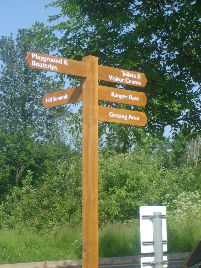 A multi- arm oak finger post with 5 directional arms to guide visitors. All timber oiled and the routed text painted white