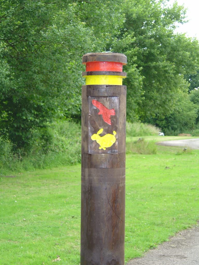 A round trail bollard in softwood – supplied with 2 routed bands and a rabbit & owl routed image to highlight the trail route