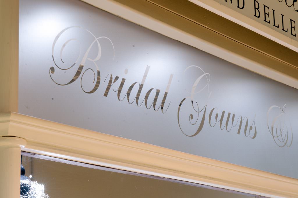 Pre-cut etched vinyl lettering  positioned in the windows of a bridal shop in Shrewsbury